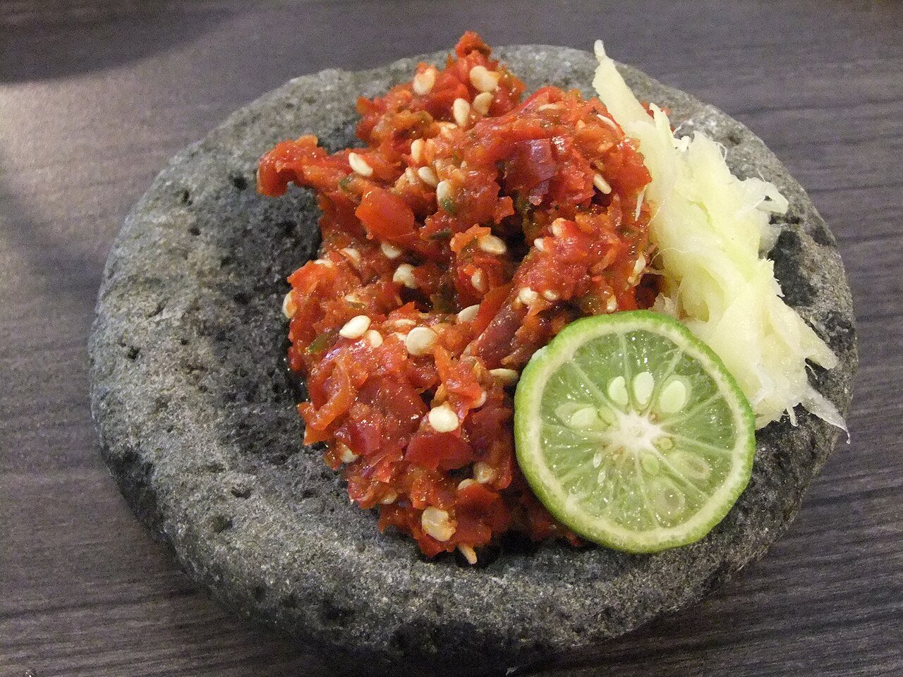 Sambal in a stone mortar with a halved lime
